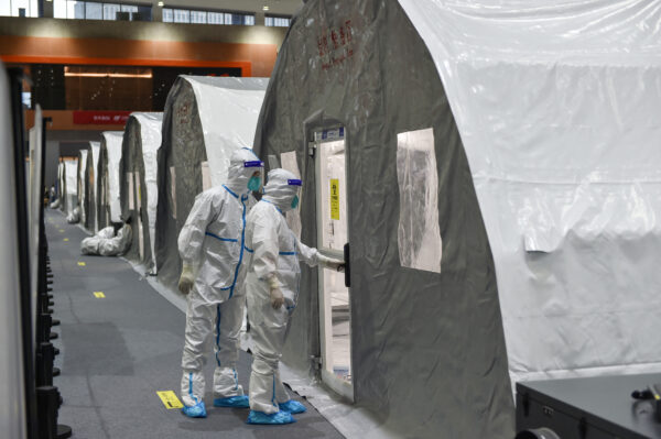 Staff members checking a unit at a temporary “Fire Eye” laboratory used for COVID-19 testing at an exhibition center in Nanjing in China’s eastern Jiangsu Province on July 28, 2021. (STR/AFP via Getty Images)