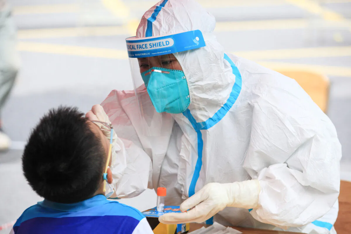 A child receives a nucleic acid test for the Covid-19 coronavirus in Nanjing, in eastern Jiangsu province on July 29, 2021.(STR/AFP via Getty Images)