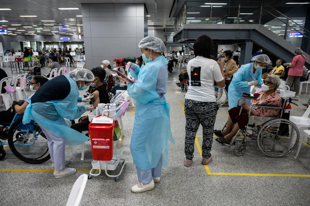 Health workers administer the AstraZeneca COVID-19 vaccines to the elderly at Central Vaccination Center in Bang Sue Grand Station in Bangkok, Thailand, on July 13, 2021. (Sirachai Arunrugstichai/Getty Images)