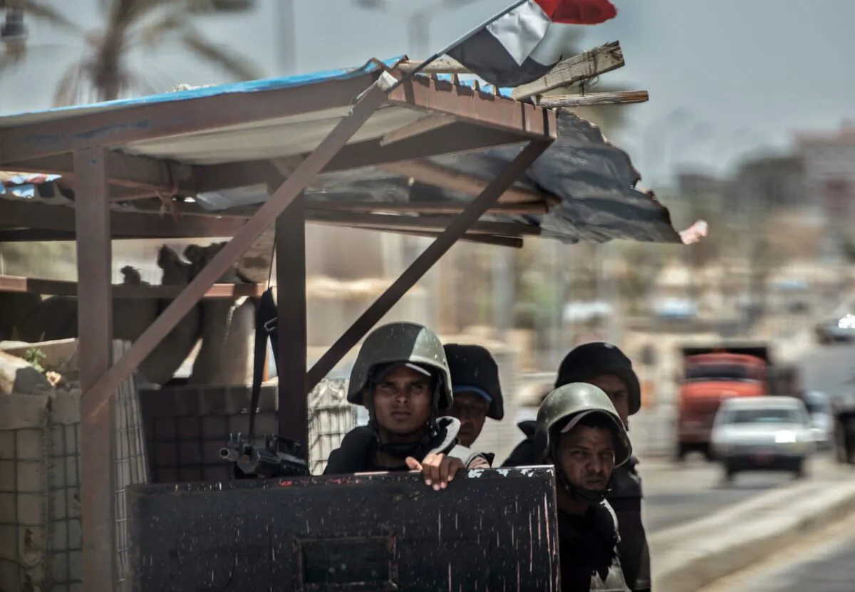 Egyptian policemen stand guarding a checkpoint on a road leading to the North Sinai provincial capital of El-Arish in a file photo. (Khaled Desouki/AFP via Getty Images)