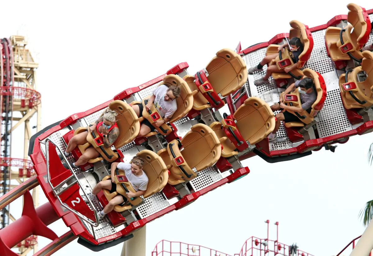 Visitors ride a roller coaster at Universal Studios theme park, in Orlando, Fa., on June 5, 2020. (Gregg Newton/AFP via Getty Images)