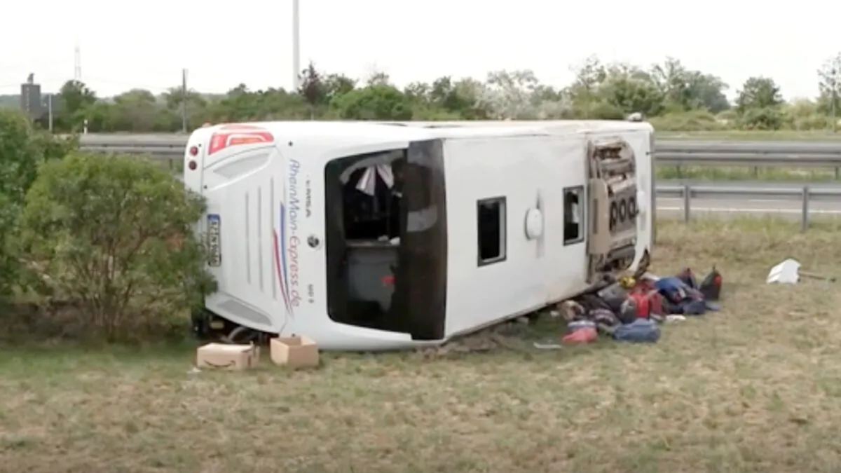 A crashed bus lies on the side in Schoenwald near Berlin, Germany, on July 30, 2021. (TNN/DPA via AP/Screenshot via NTD)