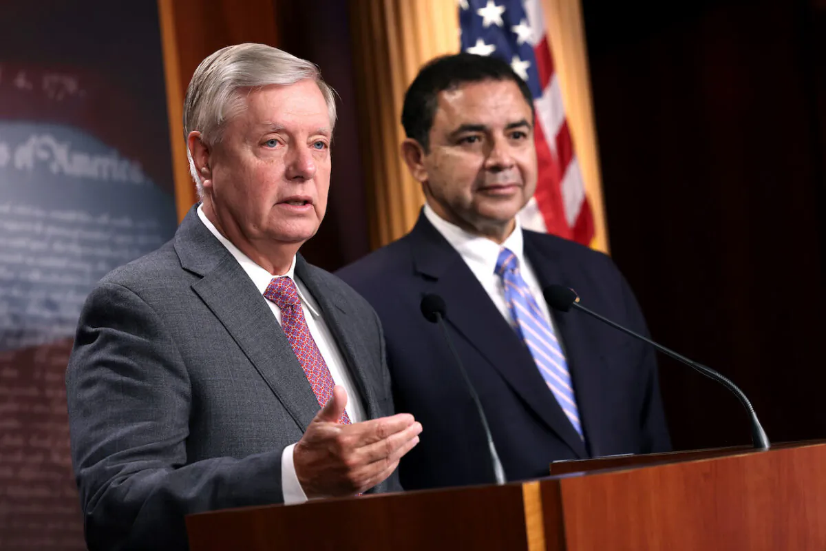 Sen. Lindsey Graham (R-S.C.) (L), joined by Rep. Henry Cuellar (D-Texas), speaks during a news conference at the U.S. Capitol in Washington, on July 30, 2021. (Kevin Dietsch/Getty Images)