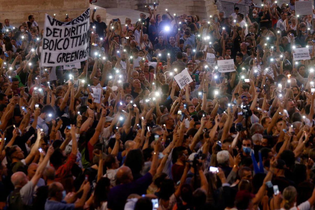 Protesters demonstrate against the Green Pass plan (health pass) in Rome on July 28, 2021. (Guglielmo Mangiapane/Reuters)