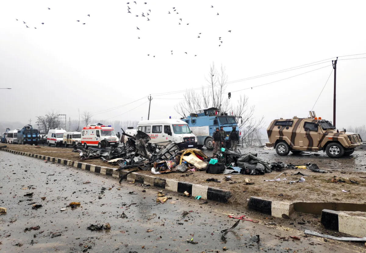 Indian soldiers examine the debris after an explosion in Lethpora in south Kashmir's Pulwama district on Feb. 14, 2019. (Younis Khaliq/File Photo/Reuters)
