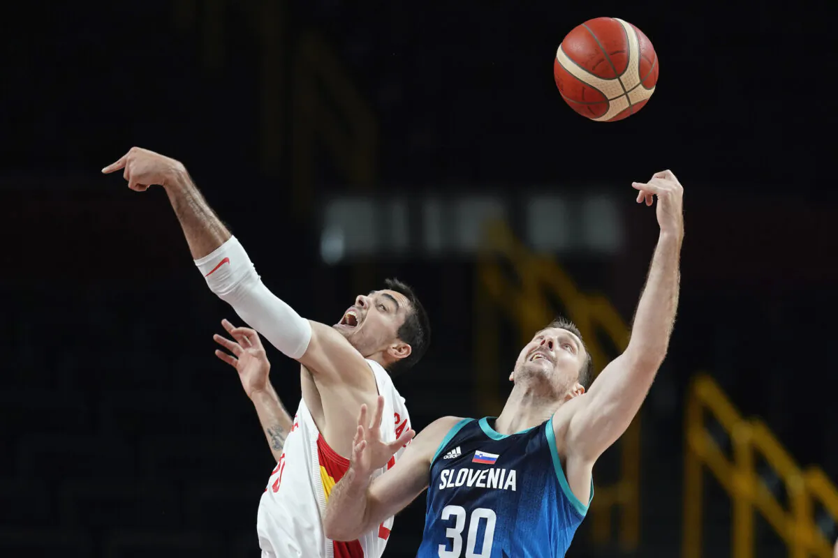 Spain’s Alberto Abalde fights for a rebound with Slovenia's Zoran Dragic (30) during a men's basketball preliminary round game at the 2020 Summer Olympics in Saitama, Japan, on Aug. 1, 2021. (Charlie Neibergall/AP Photo)