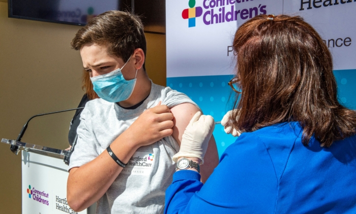 Max Zito,age 13, is inoculated by Nurse Karen Pagliaro at Hartford Healthcares mass vaccination center at the Connecticut Convention Center in Hartford, Connecticut on May 13, 2021. (Joseph Prezioso/AFP via Getty Images)