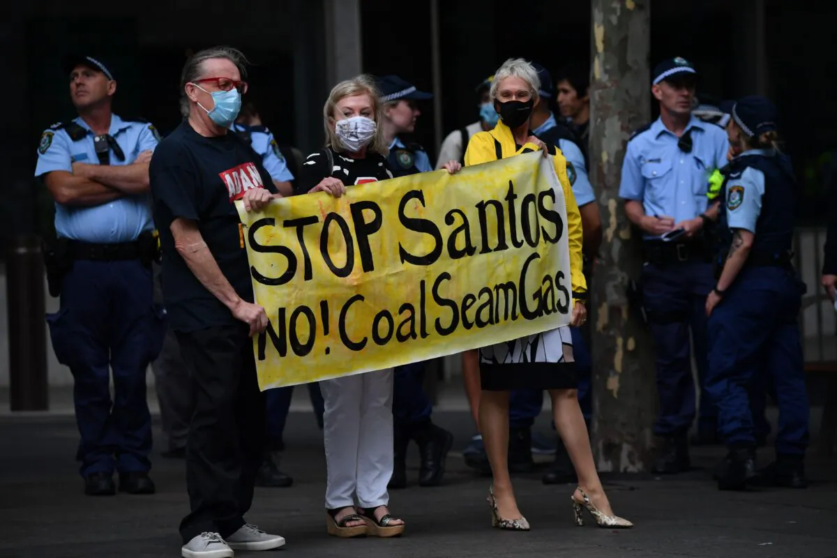 Protesters taking part in a national day of action against mining giant Santos, in Sydney, Australia on December 3, 2020. (AAP Image/Dean Lewins) 