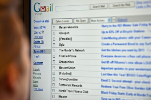 A woman looks at her email on a computer