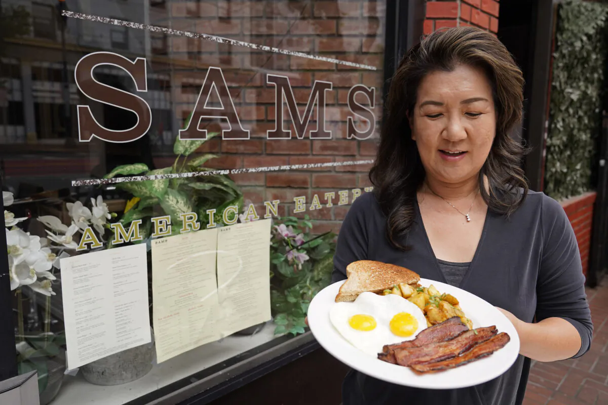 Jeannie Kim holds her popular bacon and eggs breakfast at her restaurant in San Francisco, Calif., on July 30, 2021. (Eric Risberg/AP Photo)