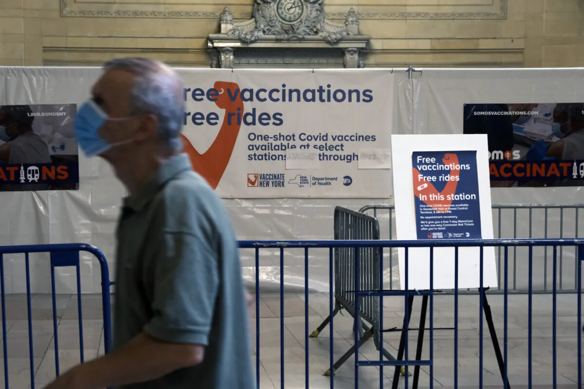 A man walks past vaccine information in Grand Central Terminal in New York on July 27, 2021. (Spencer Platt/Getty Images)
