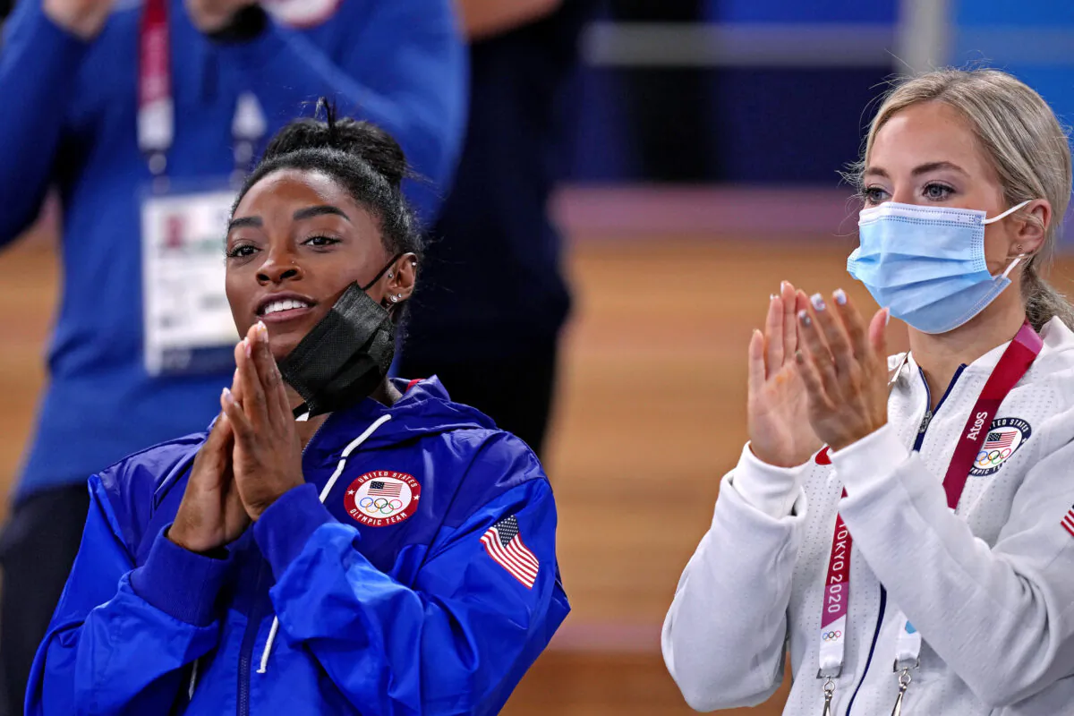 Simone Biles (L) and Mykalya Skinner (R) cheer during the Tokyo 2020 Olympic Summer Games at Ariake Gymnastics Centre on Aug. 2, 2021. (Danielle Parhizkaran/USA TODAY Sports via Reuters)