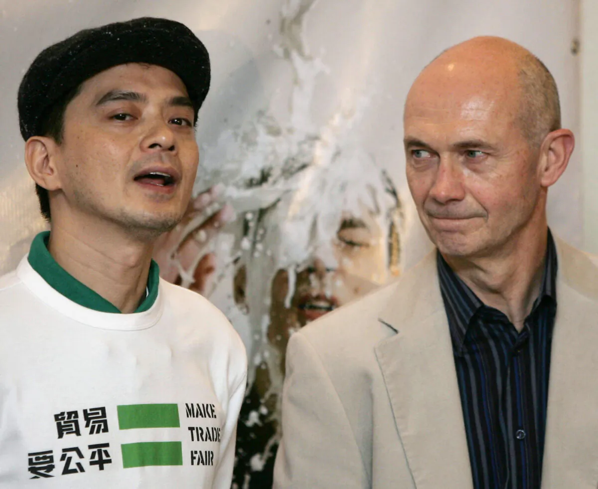 Chinese singer Anthony Wong (L) addresses the press before presenting a petition to WTO Director General Pascal Lamy (R) at the sixth WTO Ministerial Conference in Hong Kong on Dec. 12, 2005. (Mike Clarke/AFP via Getty Images)