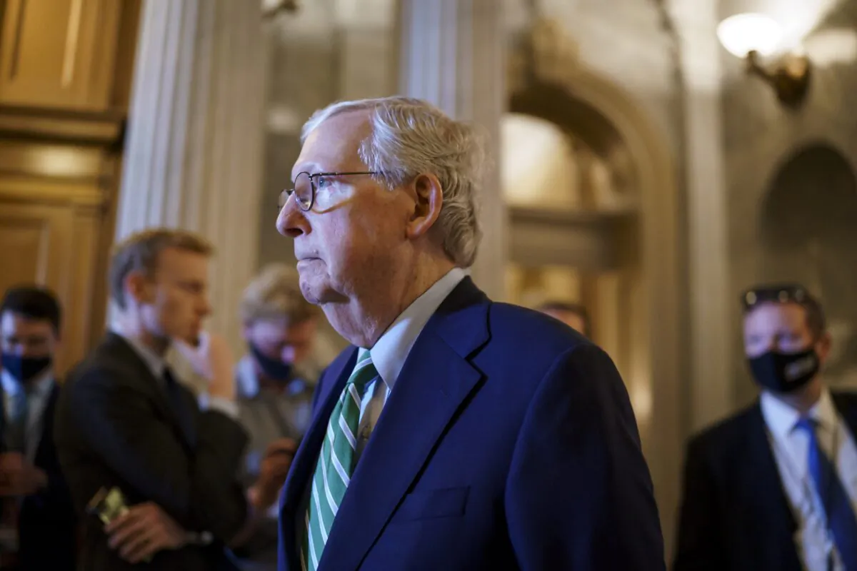Senate Minority Leader Mitch McConnell (R-Ky.) walks past the chamber as the Senate advances to formally begin debate on a roughly $1 trillion infrastructure plan, at the Capitol in Washington, on July 30, 2021. (J. Scott Applewhite/AP Photo)