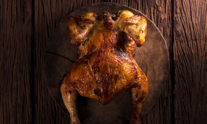A standing chicken browns more evenly and cooks faster. (Cq photo juy/Shutterstock)