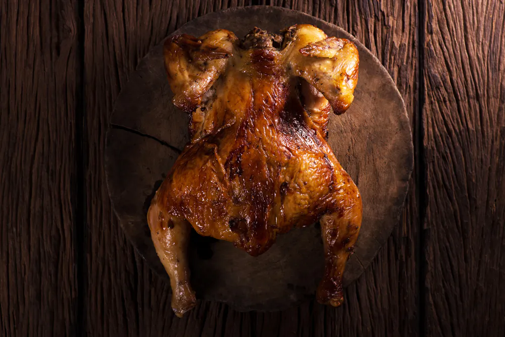 A standing chicken browns more evenly and cooks faster. (Cq photo juy/Shutterstock)