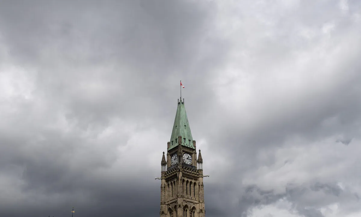 Storm clouds pass by the Peace tower and Parliament hill in Ottawa on Aug. 18, 2020. (Adrian Wyld/The Canadian Press)