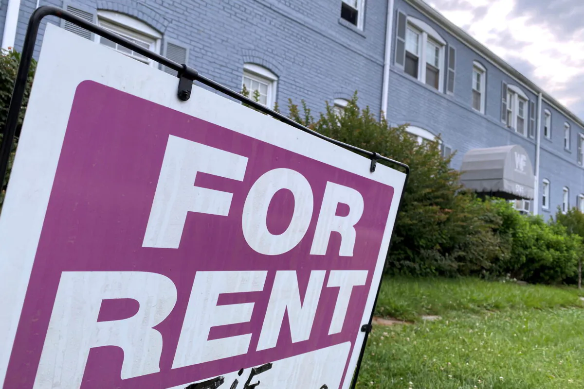 A "For Rent" sign is displayed in front of an apartment building in Arlington, Virginia, on June 20, 2021. (Will Dunham/Reuters)
