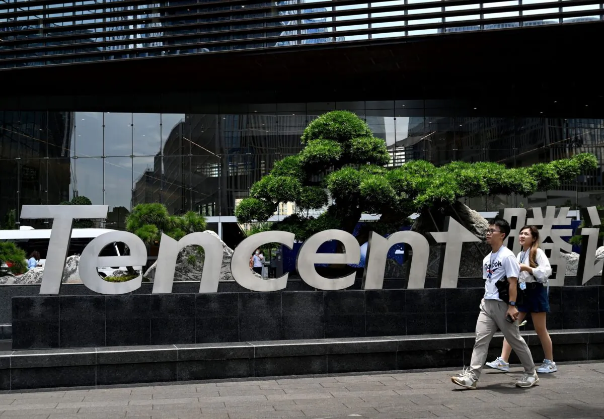 People walk past the Tencent headquarters in Shenzhen, southern China’s Guangdong Province on May 26, 2021. (Noel Celis/AFP via Getty Images)