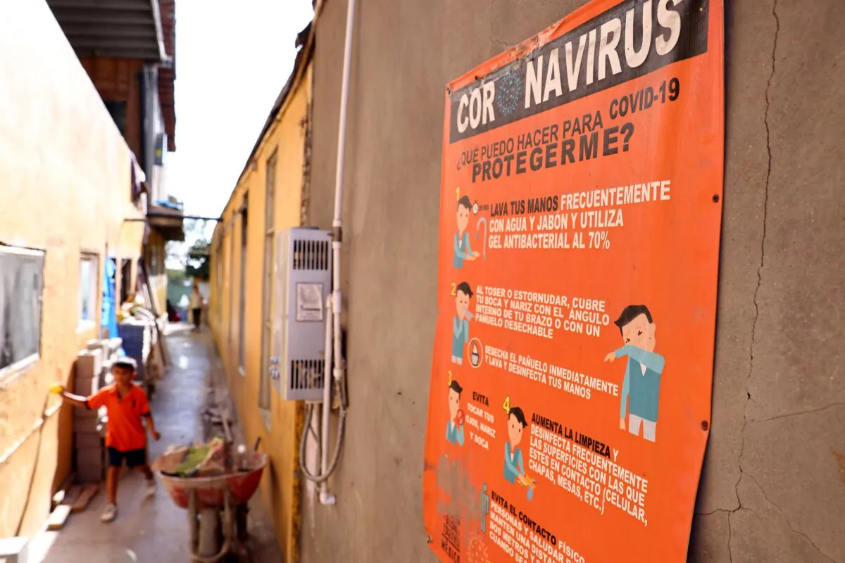 A sign is posted about how to protect against COVID-19 at a migrant shelter in Tijuana, Mexico, on July 21, 2021. (Mario Tama/Getty Images)