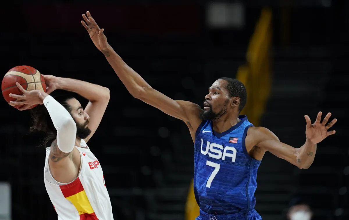 United States' Kevin Durant (7), right, covers Spain's Ricky Rubio (9), left, during men's basketball quarterfinal game at the 2020 Summer Olympics in Saitam, Japan on Aug. 3, 2021. (Charlie Neibergall/AP Photo)