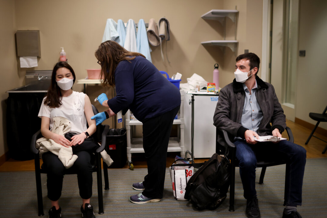 United Airlines flight attendants receive COVID-19 vaccines at United's onsite clinic at O'Hare International Airport in Chicago, Ill., on March 9, 2021. (Scott Olson/Getty Images)