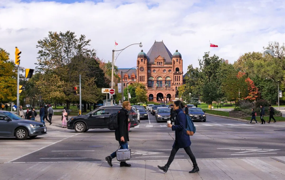Pedestrians cross University Avenue in front of the Ontario Legislative Building in Toronto in a file photo. (Vadim Rodnev/Shutterstock)