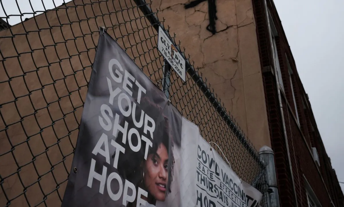 A sign asks people to get the COVID-19 vaccine in a Brooklyn neighborhood which is witnessing a rise in COVID-19 cases in New York City, on July 13, 2021. (Spencer Platt/Getty Images)