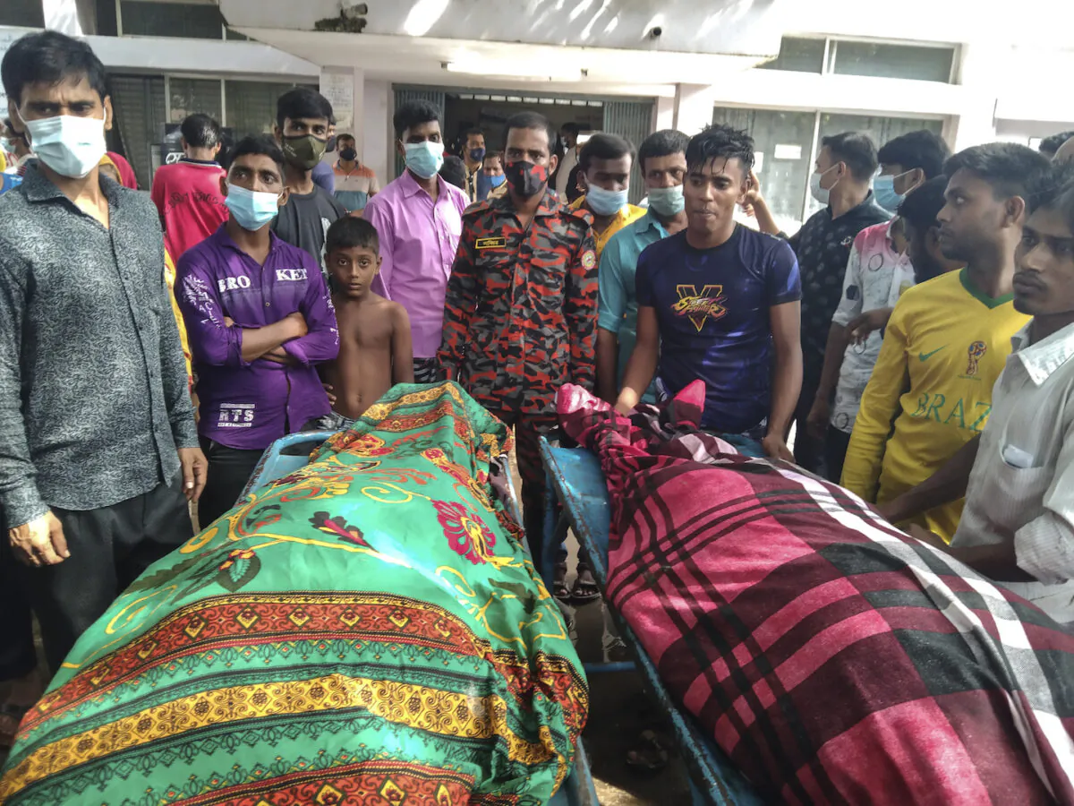 People gather around bodies of victims after lightning killed more than a dozen people in Shibganj in Chapainawabganj district, about 150 miles northwest of Dhaka, Bangladesh on Aug.4, 2021. (Md Jahangir Alom/AP Photo)
