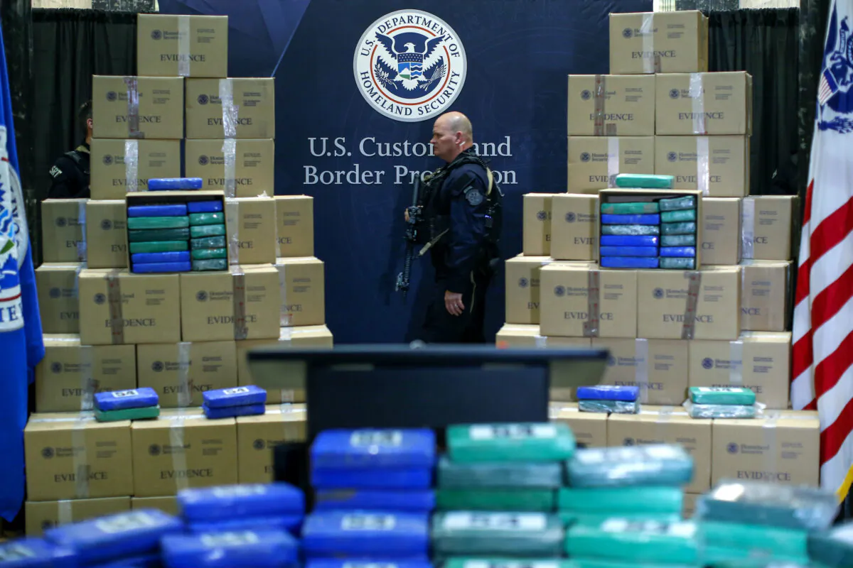 A police officer walks near cocaine seized from a cargo ship at a Philadelphia port during a news conference at the U.S. Custom House in Philadelphia, Pa., on June 21, 2019. (Eduardo Munoz Alvarez/Getty Images)