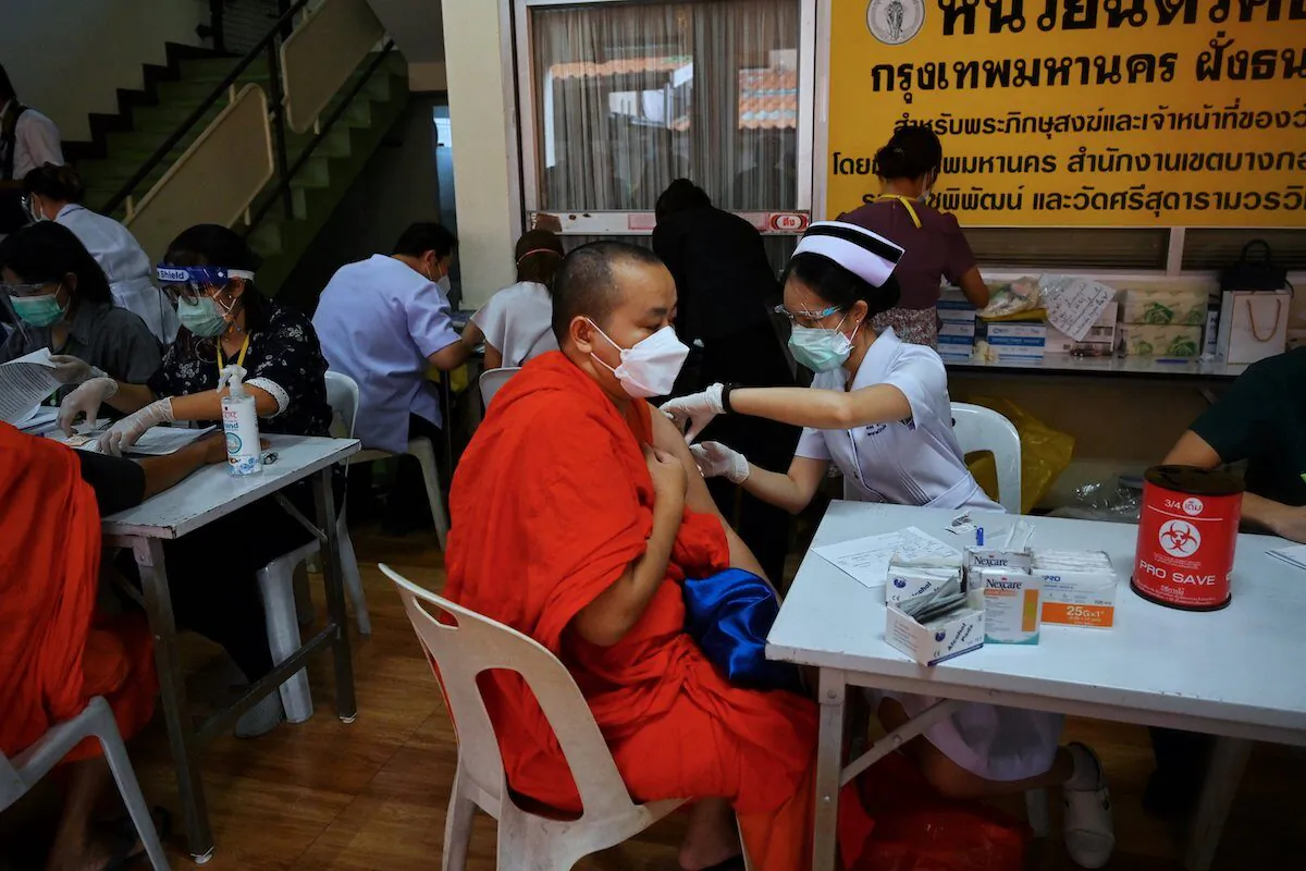 Buddhist monks receive a COVID-19 vaccine shot dose at Wat Si Sudaram Worawihan in Bangkok on July 30, 2021. The U.S. this week officially delivered 1.5 million vaccine doses to Thailand. The U.S. will be giving an additional million doses to further help the country fight the pandemic. (Lillian Suwanrumpha/AFP) 