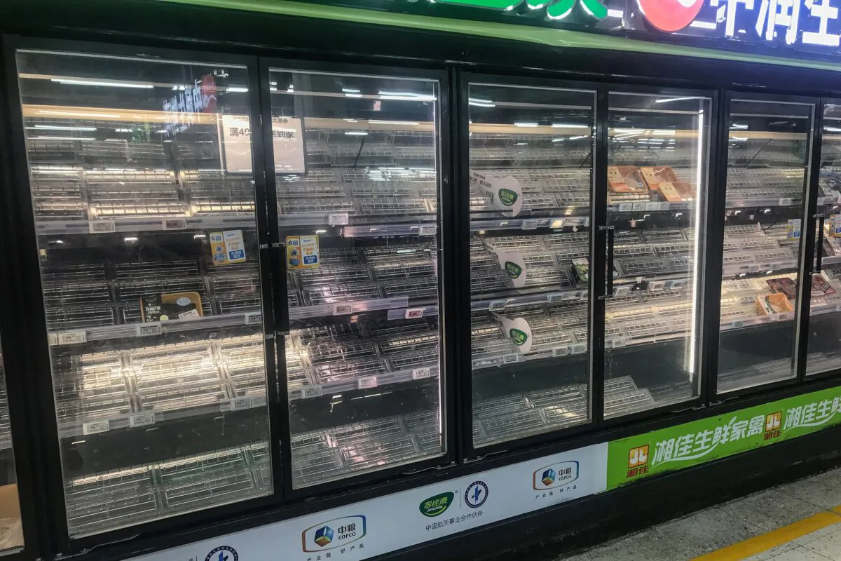 Empty shelves are seen as people buy items at a supermarket in Wuhan, in China's central Hubei Province, on Aug. 2, 2021. (STR/AFP via Getty Images)
