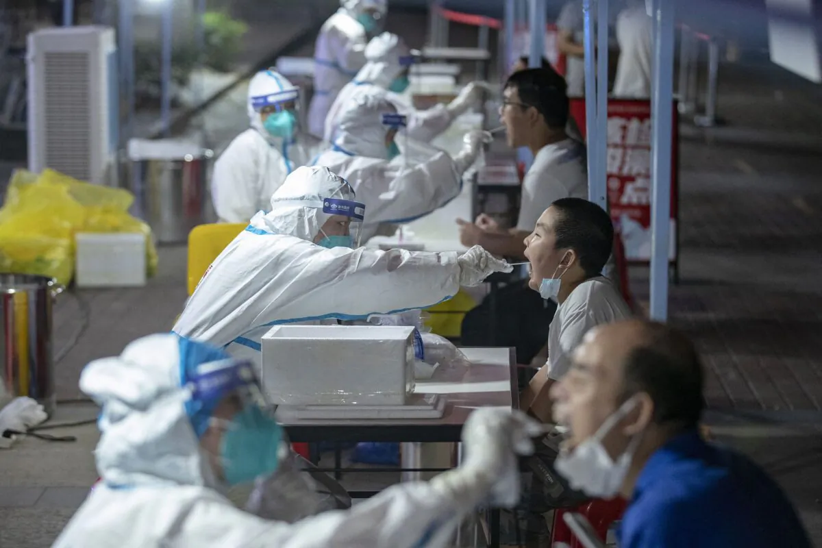 Residents are receiving nucleic acid tests for the coronavirus in Wuhan in China's central Hubei province on Aug. 3, 2021. (STR/AFP via Getty Images)