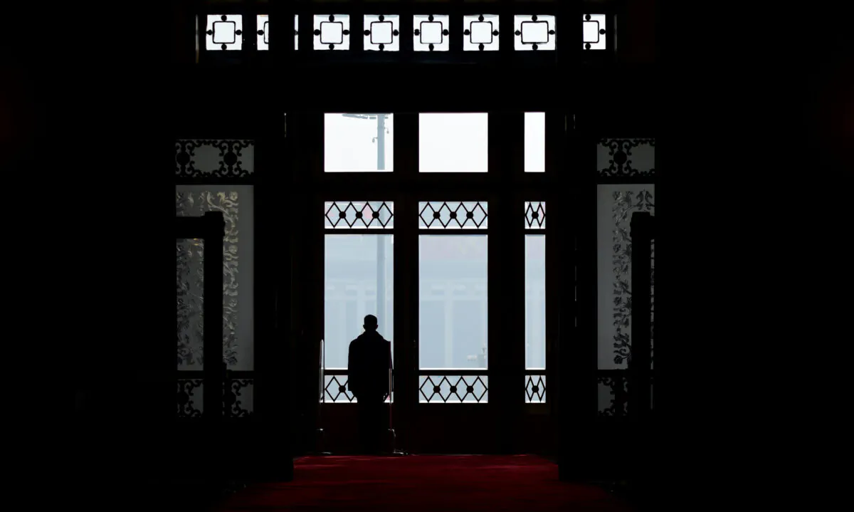 A security guard stands at the entrance of the Great Hall of the People during the fourth plenary session of the first session of the 13th National People's Congress in Beijing on March 13, 2018. (Wang Zhao/AFP via Getty Images)