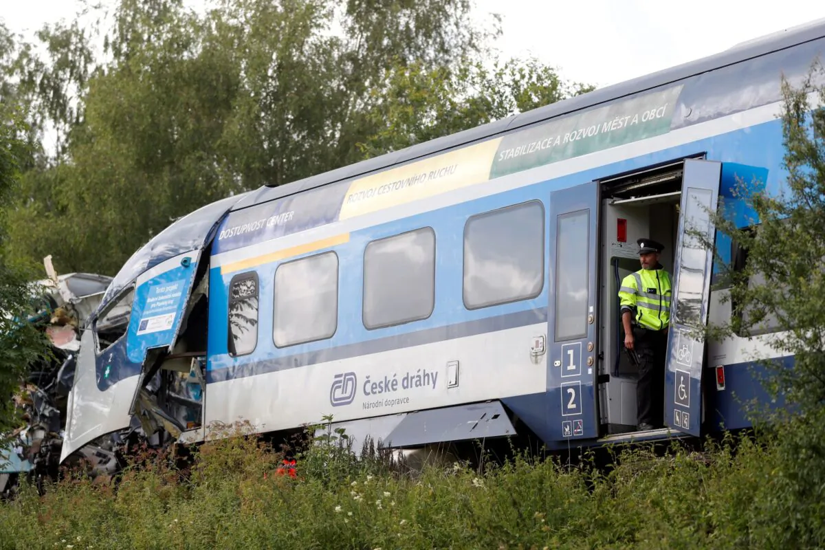 A police officer looks on from a carriage on a site of a train crash near the town of Domazlice, Czech Republic, on Aug. 4, 2021. (David W Cerny/Reuters)