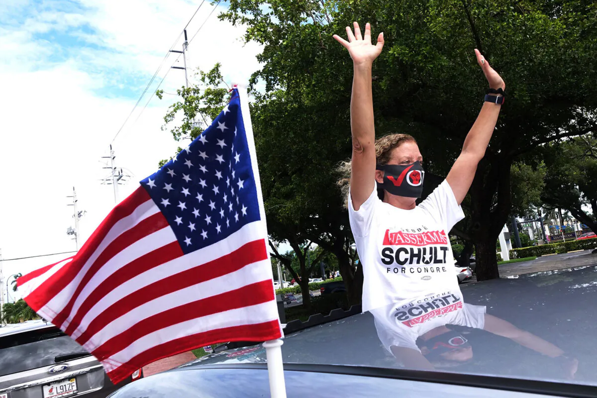 U.S, Rep. Debbie Wasserman Schultz (D-Fla.) waves to supporters as part of a mobile Souls to the Polls car parade in Hallandale Beach, on Oct. 25, 2020. (Joe Cavaretta/Sun Sentine/TNS)