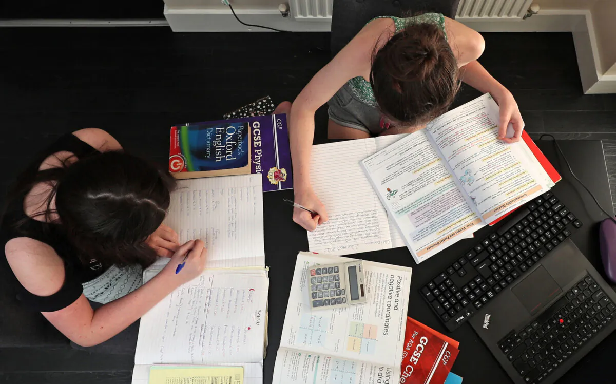 Children taking part in home schooling, studying mathmatics, english and sciences from their home in Liverpool, United Kingdom, on April 20, 2020. (Peter Byrne/PA)