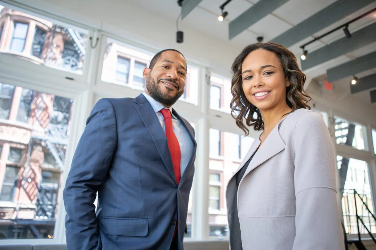 A businessman and businesswoman in formal attire. (Pexels)