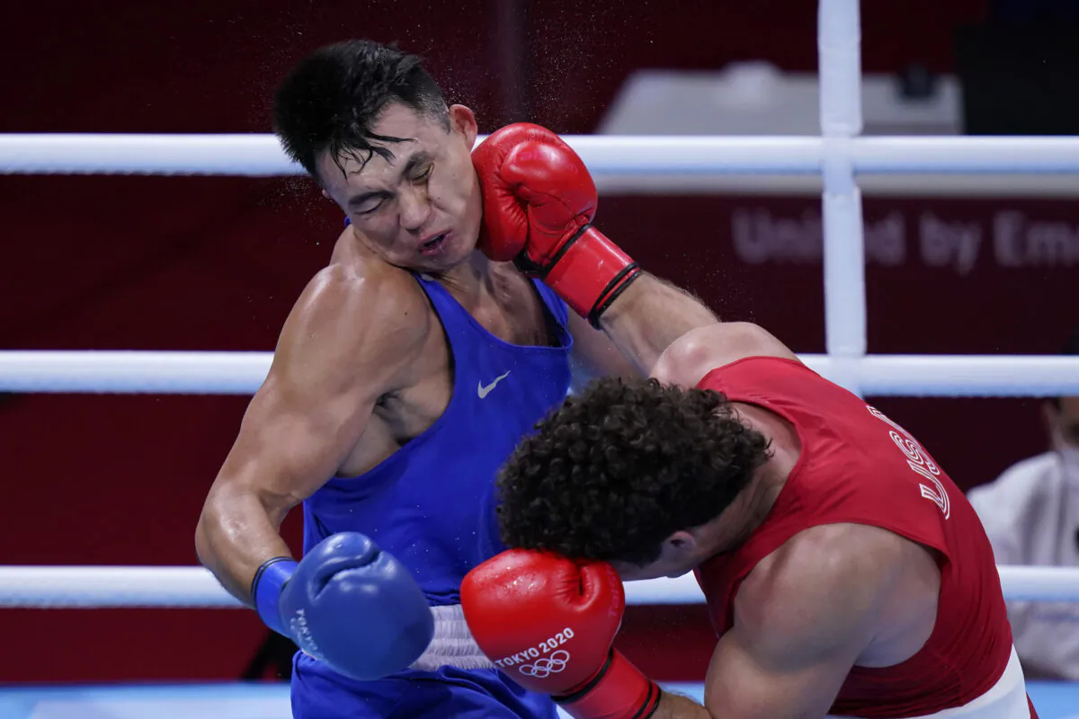 Richard Torrez Jr., of the United States, right, lands a shot to the face of Kamshybek Kunkabayev, of Kazakhstan, during their super heavy weight +91kg semifinal boxing match at the 2020 Summer Olympics, in Tokyo, Japan, on  Aug. 4, 2021. (Frank Franklin II/AP Photo)