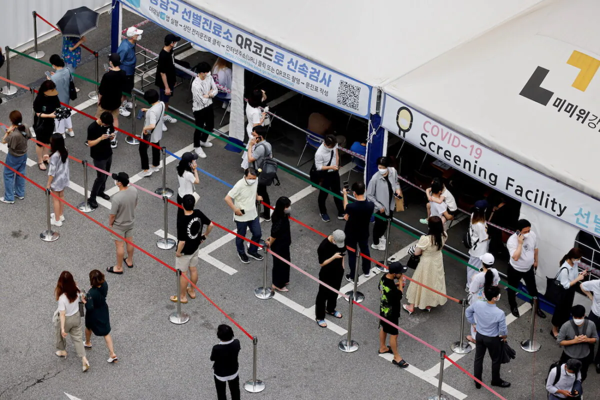 People wait in line for a COVID-19 test at a testing site that is temporarily set up at a public health center in Seoul, South Korea, on July 9, 2021. (Heo Ran/Reuters)