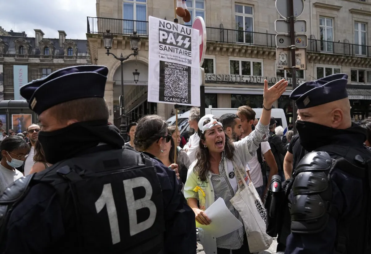 Anti heath pass demonstrators face police officers outside the Constitutional Council in Paris, on Aug. 5, 2021. (Michel Euler/AP Photo)