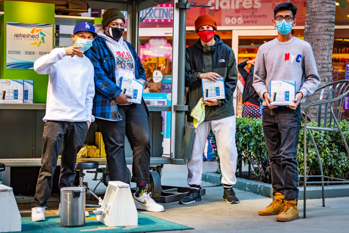 Retail workers display their product at the Block at Orange outlet shops in Orange, Calif., on Nov. 27, 2020. (John Fredricks/The Epoch Times)