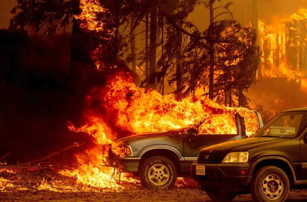 Vehicles and a home are engulfed in flames as the Dixie fire rages on in Greenville, Calif., on Aug. 5, 2021. (Josh Edelson/AFP via Getty Images)