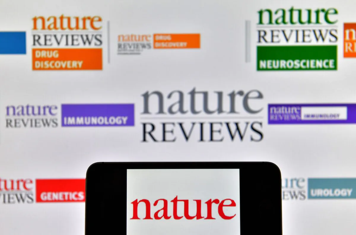 Lgos of multidisciplinary scientific journal Nature displayed on computer screens. (Loic Venance/AFP via Getty Images)
