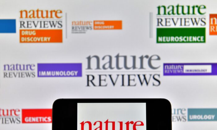 Lgos of multidisciplinary scientific journal Nature displayed on computer screens. (Loic Venance/AFP via Getty Images)