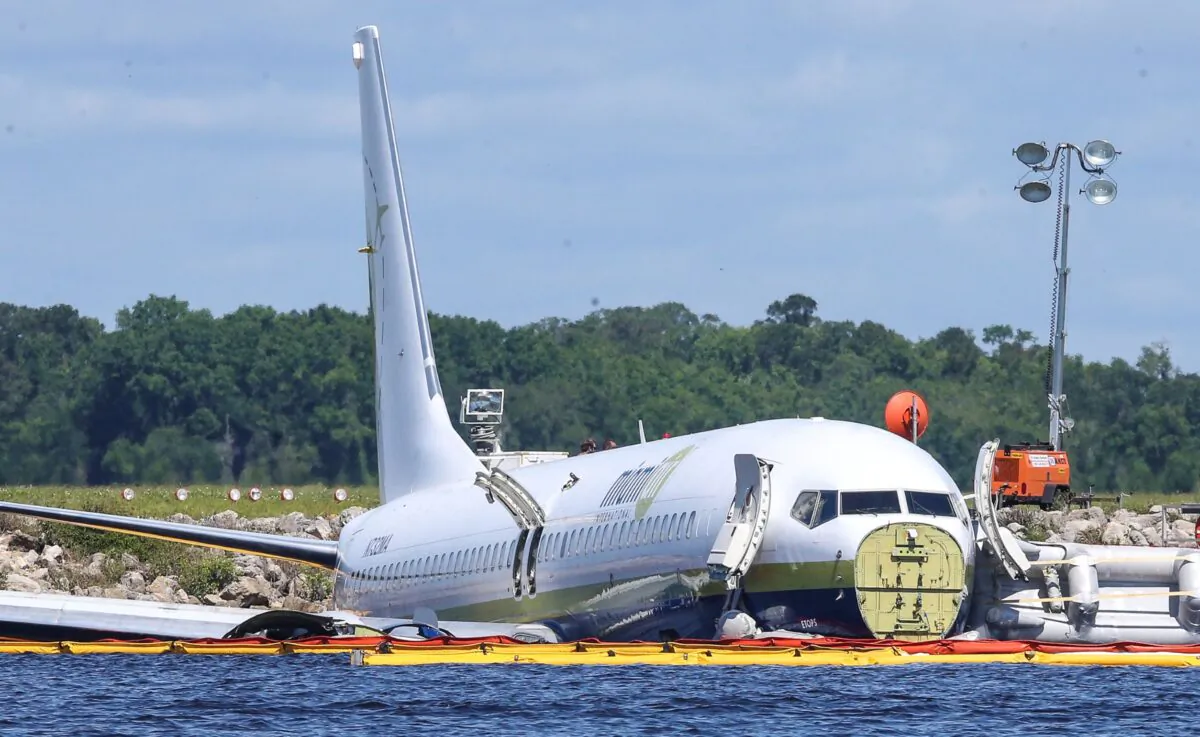 A charter plane carrying 143 people and traveling from Cuba to north Florida sits in a river at the end of a runway in Jacksonville, Fla., on May 4, 2019. (Gary McCullough/File/AP Photo)