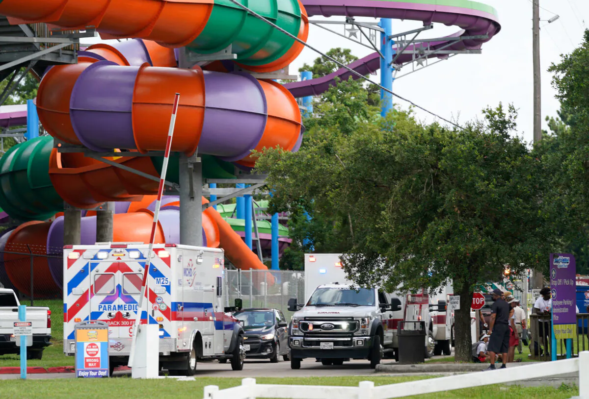 Emergency personnel are shown on scene where people are being treated after chemical leak at Six Flags Hurricane Harbor Splashtown in Spring, Texas, on July 17, 2021. (Melissa Phillip/Houston Chronicle via AP)