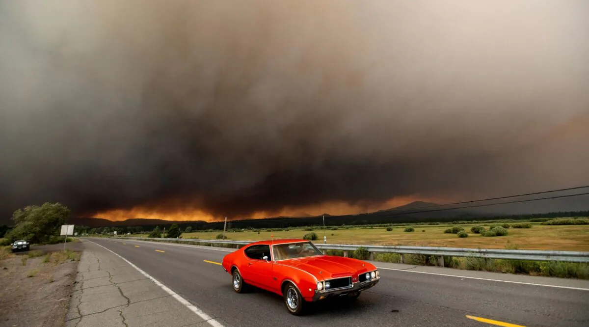 A car leaves Chester, Calif., which is under mandatory evacuation orders, as the Dixie Fire burns on the edge of town on Aug. 4, 2021. (Noah Berger/AP Photo)
