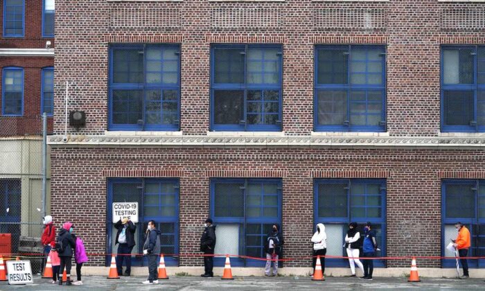People wait in line to get tested for COVID-19 at the Ann Street School Covid-19 Testing Center in Newark, N.J., on Nov. 12, 2020. (Timothy A. Clary/AFP via Getty Images)