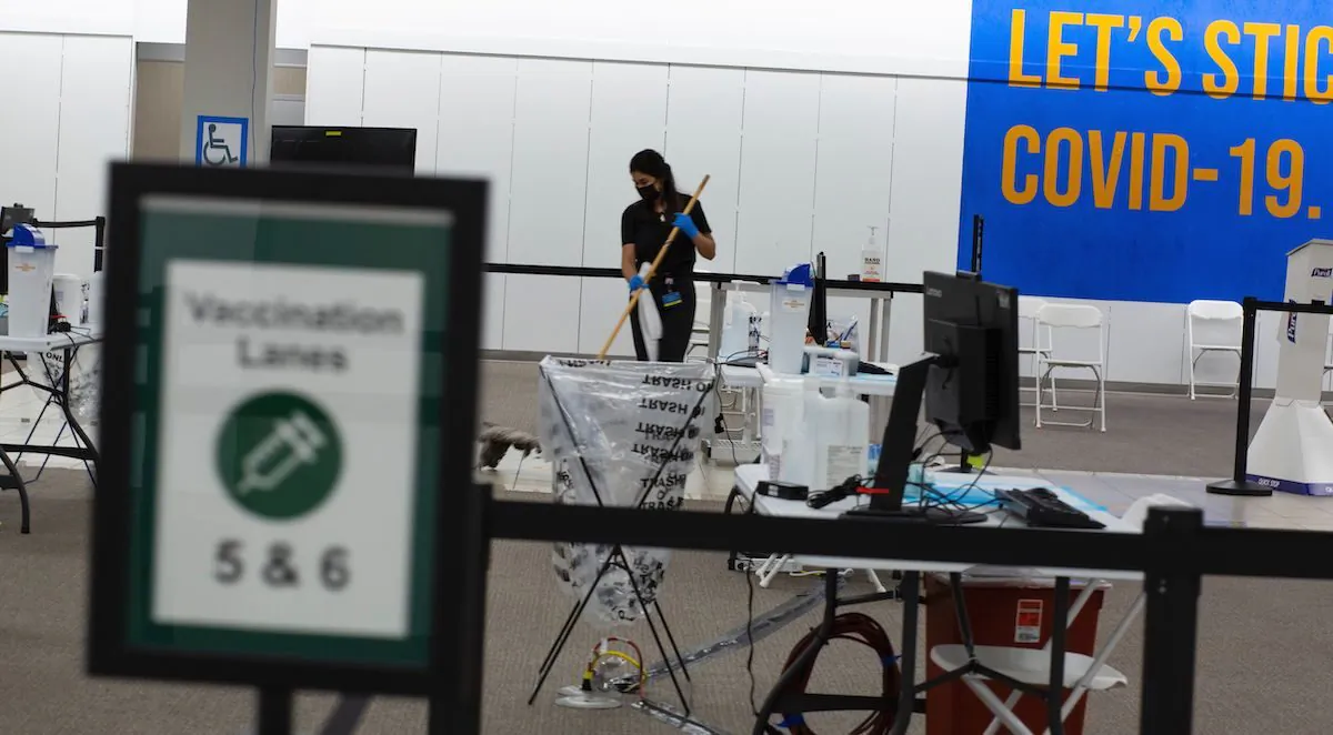 A worker cleans on the vaccination area of the Townsquare Mall in Rockaway, New Jersey on Jan. 8, 2021. (Kena Betancur/AFP via Getty Images)